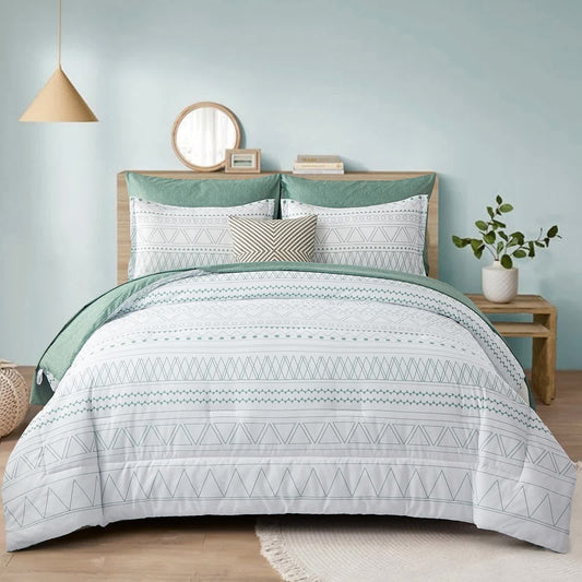 Comforter and pillow covers with white base, green and gray tribal pattern in a bedroom set