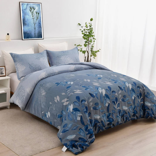 Blue comforter and pillow shams with botanical leaf print, bed angled view