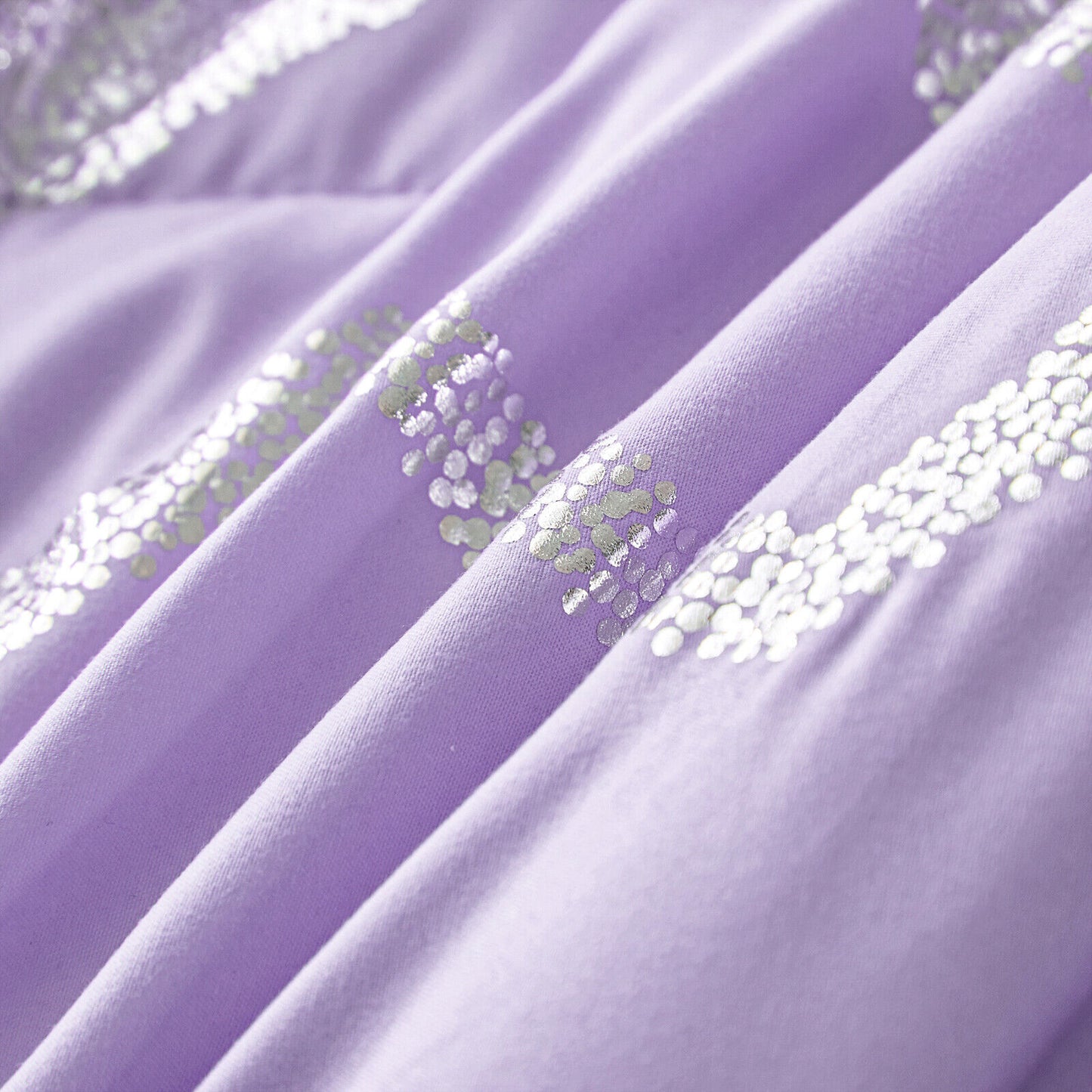Lavender fabric folds with silver sequin zigzag dots