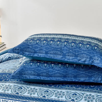 Close view of blue boho comforter with ornate floral and scroll pattern