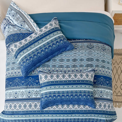 Boho bedding set with blue comforter and multiple patterned pillow covers on bed