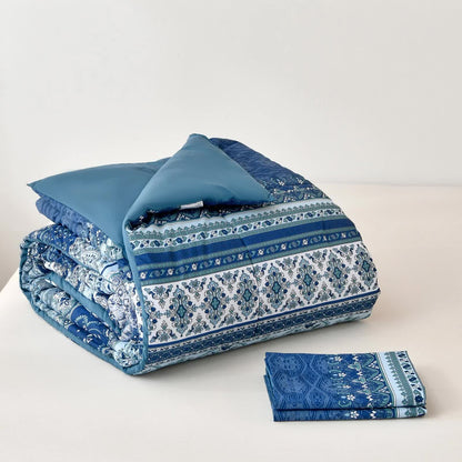 Folded blue boho comforter with matching patterned pillow covers