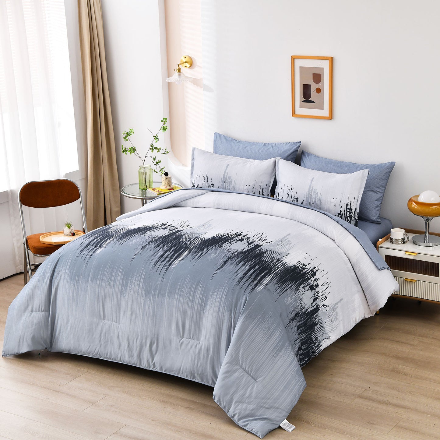 King comforter set with light blue comforter and white/black patterned pillowcases