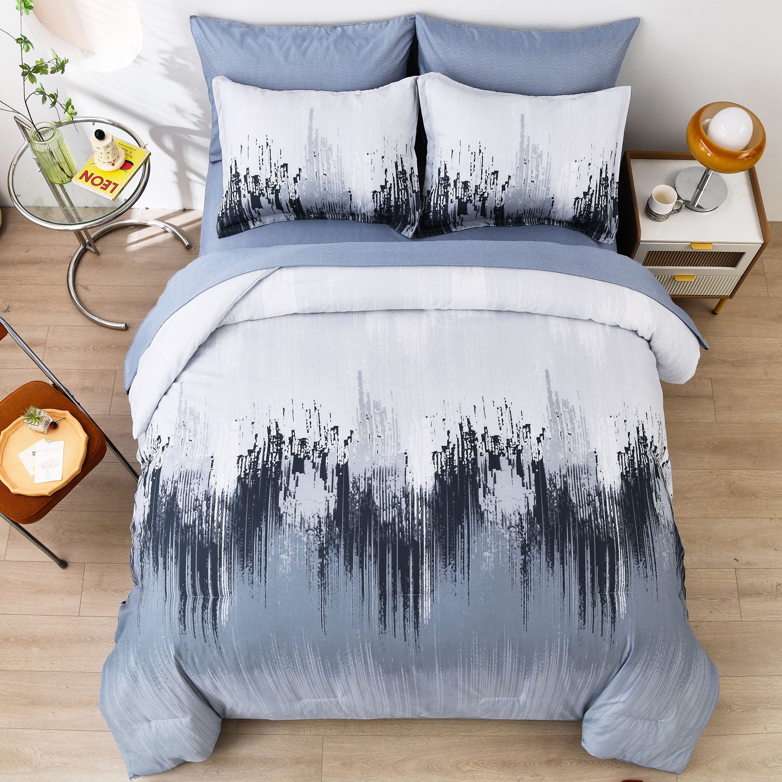 King comforter set featuring light blue bedding with white and black abstract stripe pillows