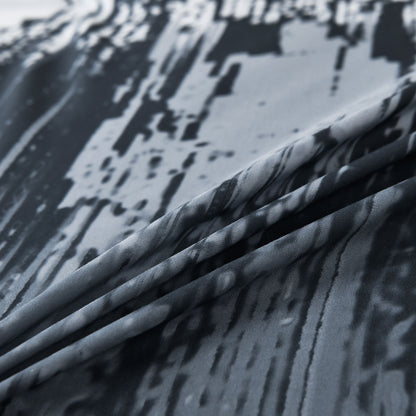 Close-up of light blue comforter fabric with white and black abstract stripe print