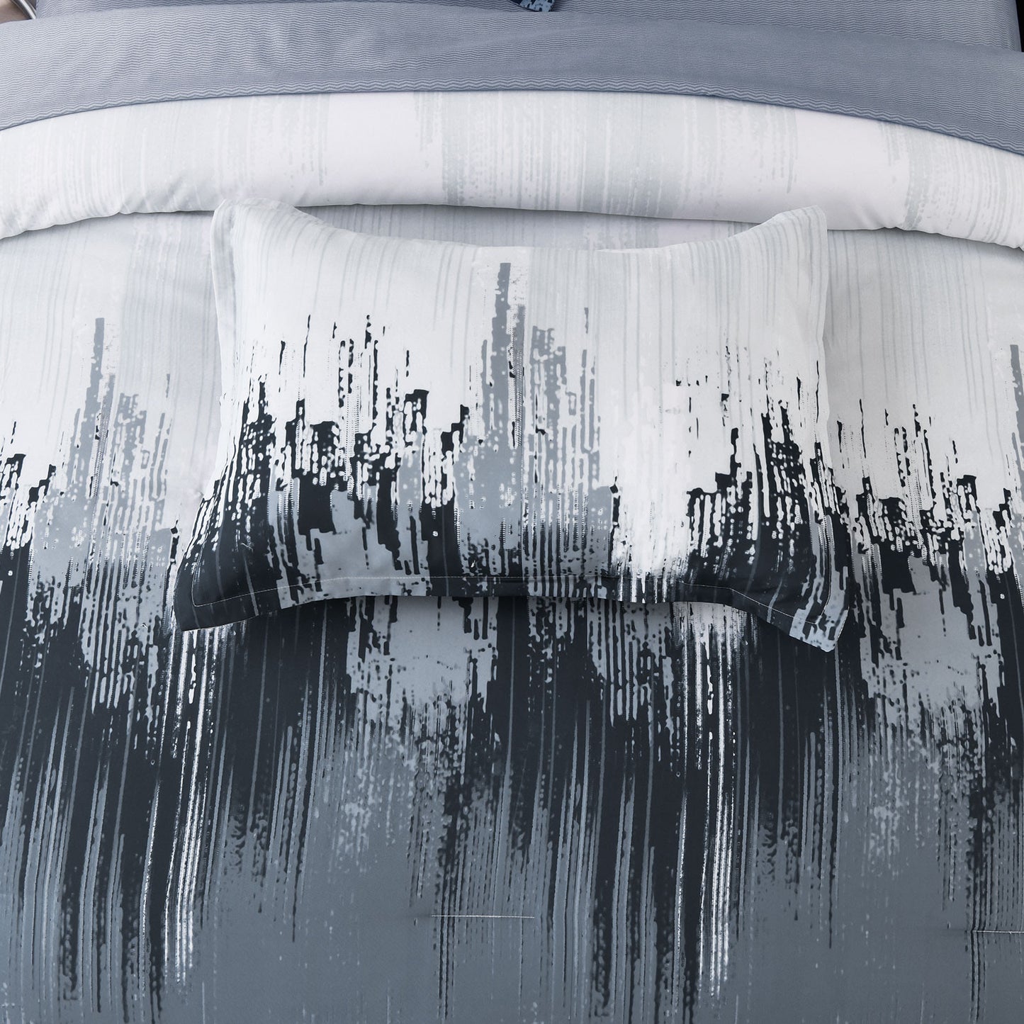 Pillowcase close-up with white background and black abstract brush stripe pattern