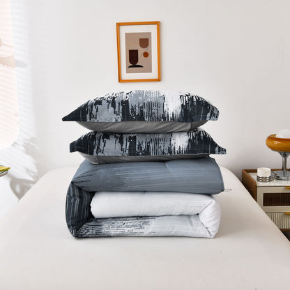 Stacked bedding set with dark and light blue comforter and matching patterned pillowcases