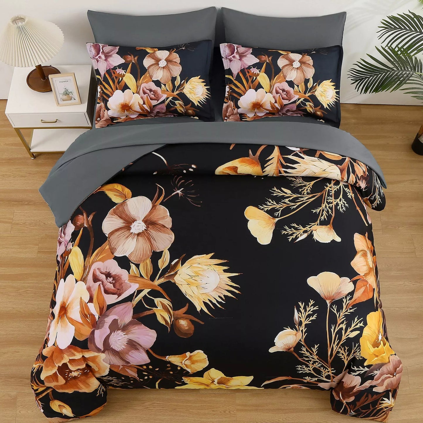 Quilted comforter set with black floral print, gray bed skirt, and two square pillows
