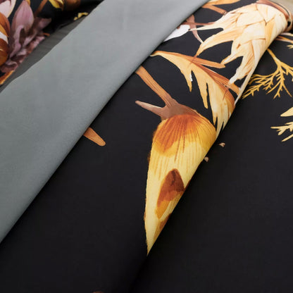 Quilted comforter corner with black base, large tropical flower and gray border