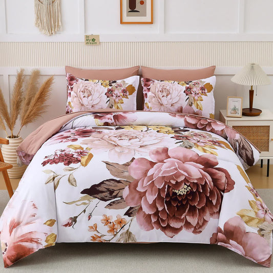 Pink floral comforter set with matching pillowcases and blush border