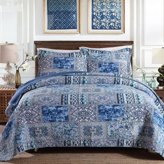 Blue patchwork quilt coverlet set with coordinating square throw pillows