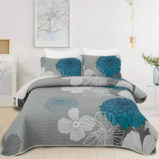 Grey quilted bedspread with blue and white floral pattern, plus two matching pillow covers