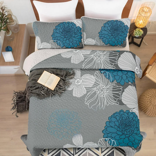 Grey bedspread with blue floral and white outlines, with two matching decorative pillow covers