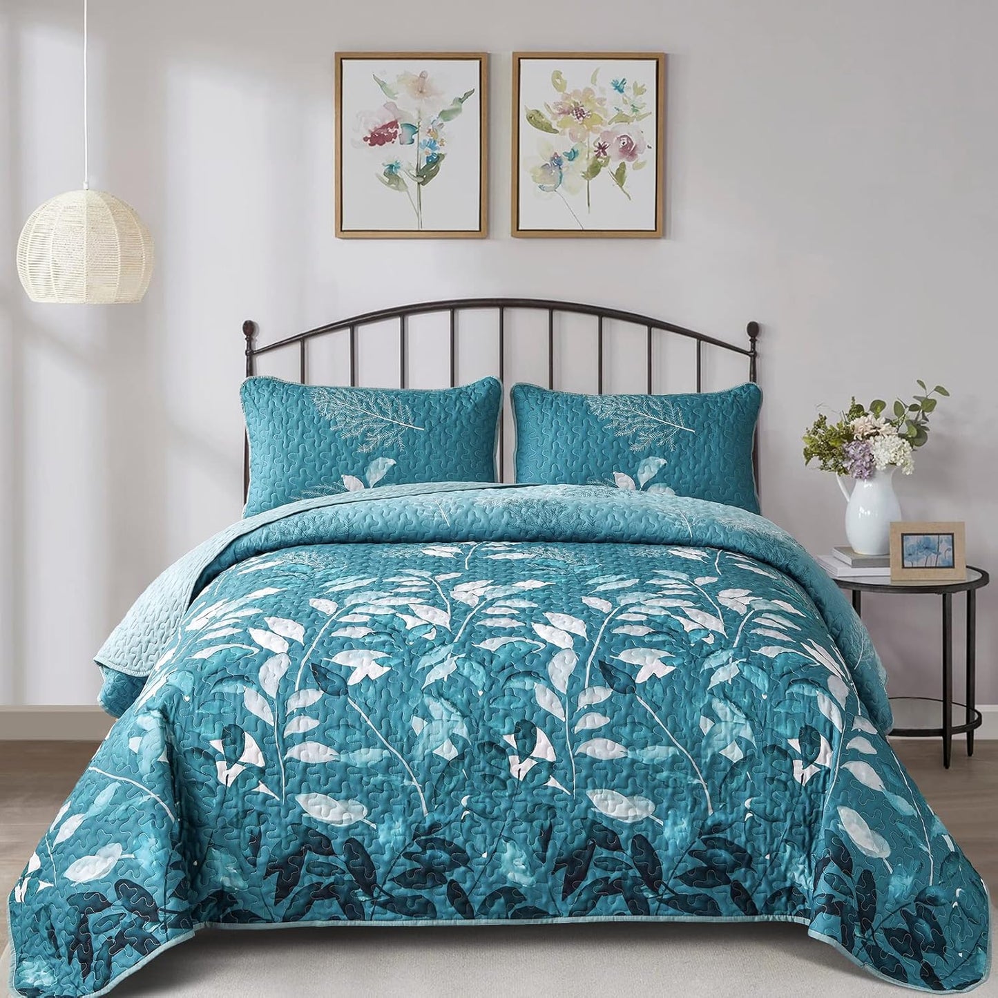 Queen quilt coverlet set with teal botanical leaf pattern and matching pillowcases