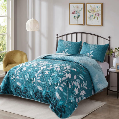 Queen quilt coverlet set with teal leaf-print bedding and two matching throw pillows