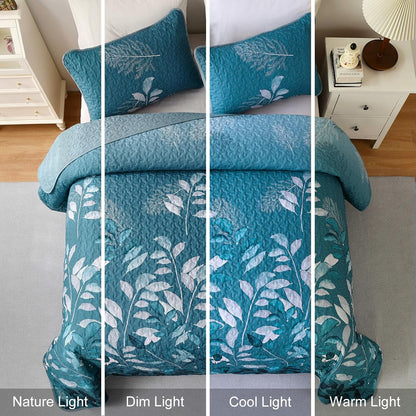 Teal quilt coverlet with botanical leaf design and textured stitched surface