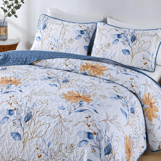 Floral quilt coverlet with blue leaf print and tan flowers; two coordinating pillowcases