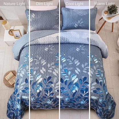 Blue botanical leaf quilted coverlet with matching pillow shams, close-up view