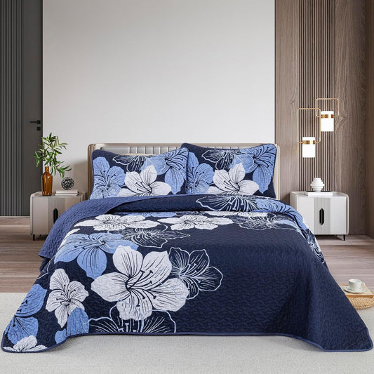 Quilted coverlet and pillowcases set with navy-blue base and white floral pattern