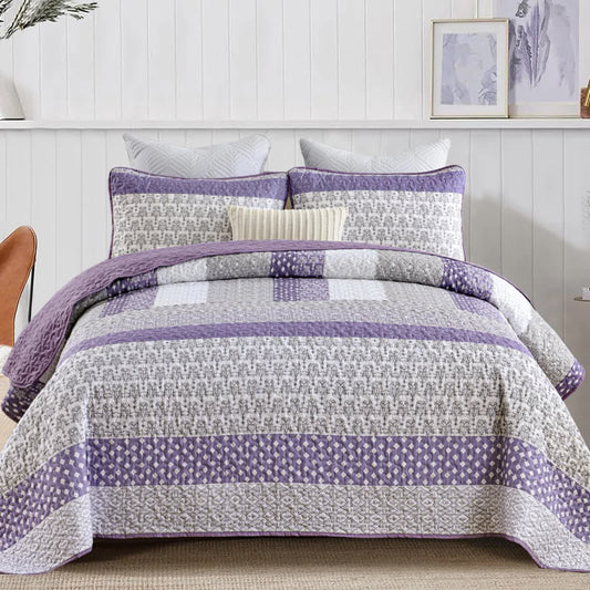 Quilted bedspread set with purple and white geometric patchwork and striped border
