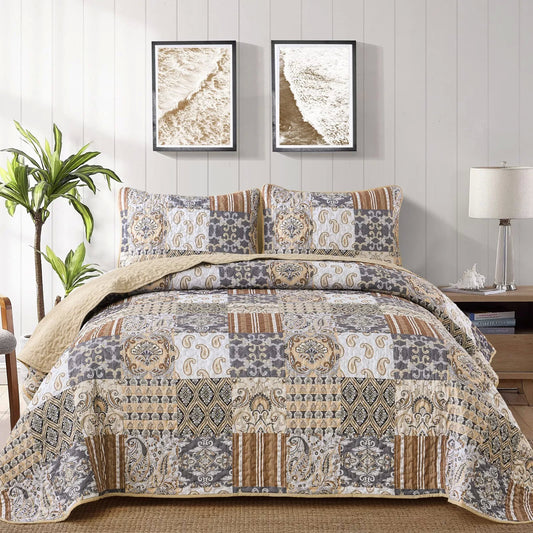 Quilted coverlet and pillow cover set with paisley patchwork in blue-gray and tan.
