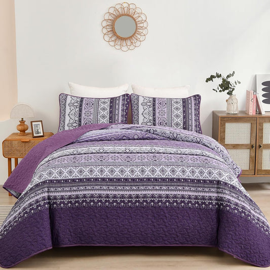 Purple quilted bedspread with grey and white ornamental stripe and two pillowcases