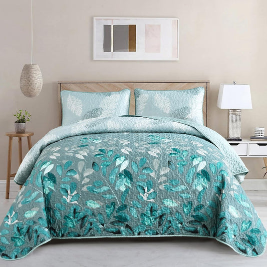 Turquoise botanical quilted bedspread with matching light blue pillowcases