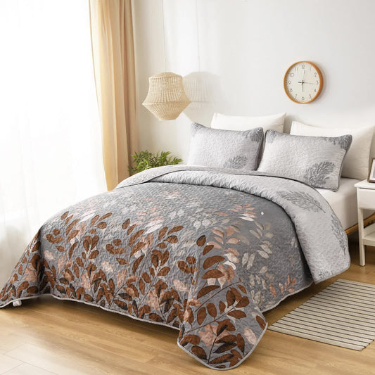 Quilted bedspread with rust-brown leaf pattern on gray, with matching pillowcases