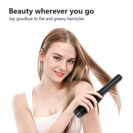 Black 2-in-1 wireless USB hair curler and flat iron held near hair