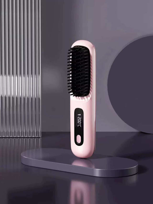 Pink hair straightening brush with black bristles, compact handheld design