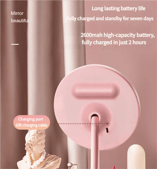 Pink round LED vanity mirror with charging port on the back and tabletop base