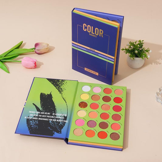 Eyeshadow palette book with open cover and multi-tone pan shades in green and red
