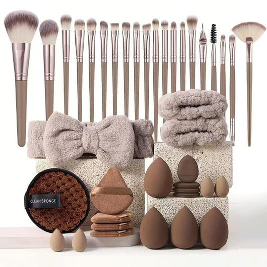 Beauty tool kit brushes with brown handles, bow, and stacked cleansing sponges