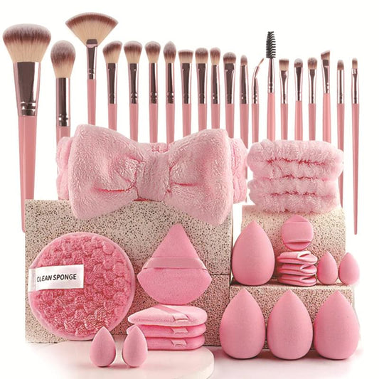 Beauty tool kit with pink makeup brushes, sponges, and cleaning accessories