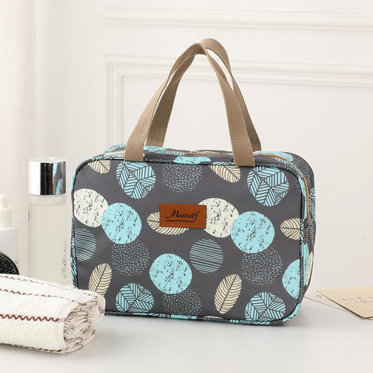 Navy leaf-pattern toiletry bag with top handle and zipper
