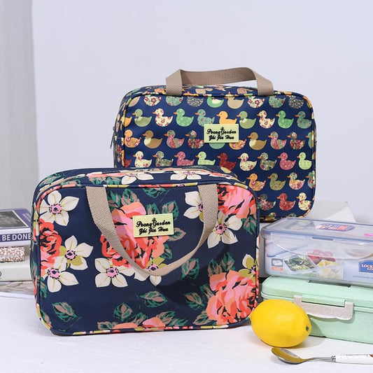 Navy zip toiletry bag with colorful graphic print and carry handles