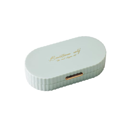 Pale green compact manicure case with gold-toned clasp detail.