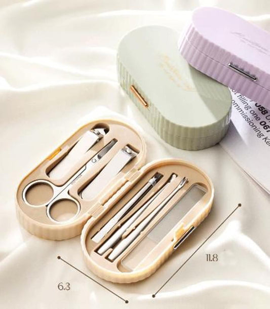 Beige manicure set case open with nail clippers, scissors, and grooming tools.