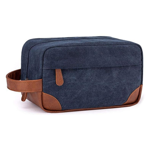 Canvas toiletry bag with handle, dark blue fabric and brown trim, front zipper