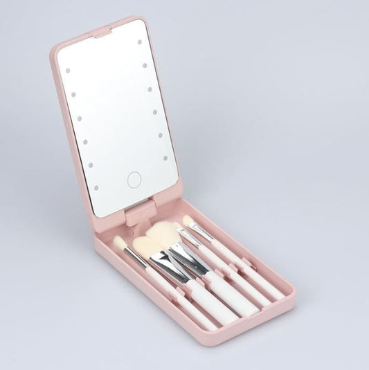 Pink foldable LED vanity mirror case with makeup brushes, open