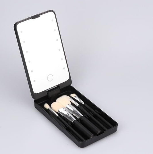 Foldable black LED makeup mirror case with brush set, open to show lit mirror surface