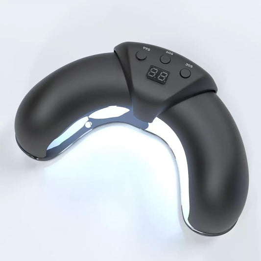 Portable UV nail lamp with open arch and digital timer display, dark gray/black.