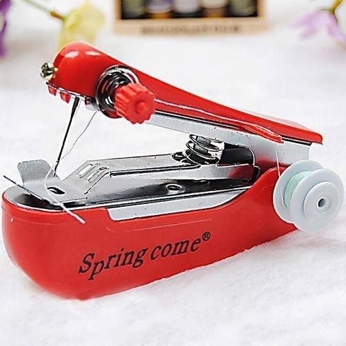 Red mini handheld sewing machine with front needle plate and thread spool