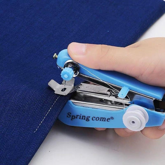 Blue mini handheld sewing machine held over fabric with needle and presser foot