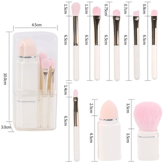 Makeup brush set with pink bristles, white handles, and clear storage case