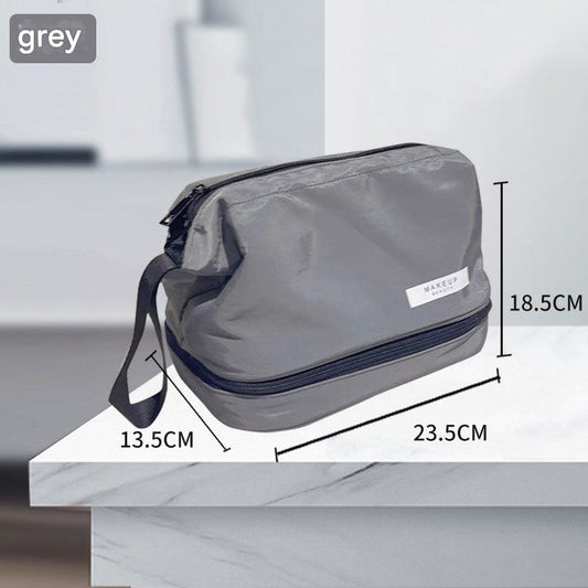 Grey cosmetic travel bag with front white label and wide zipper opening