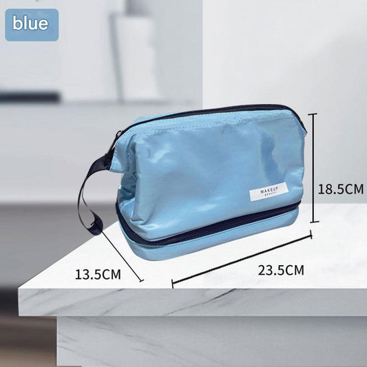 Blue makeup toiletry bag with zip closure, side strap, and dual compartments