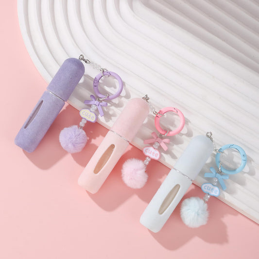 Set of plush perfume atomiser keychains with pom pom charms and rings