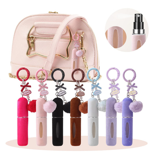Plush perfume atomiser keychains with pom pom charms and mini spray bottles, assorted colors