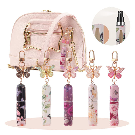 Pink mini perfume atomizer keychains with butterfly charms and floral print bottles